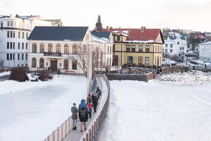 A group of people walks along a bridge on the Reykjavík VIP CityWalk Tour, one of the best Iceland tours with kids.