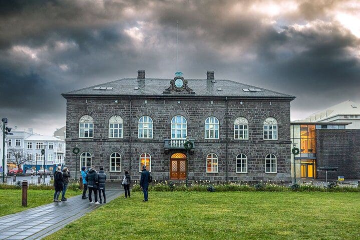 A group of people explore historic grounds on the Reykjavik Walking Tour - Walk with a Viking.