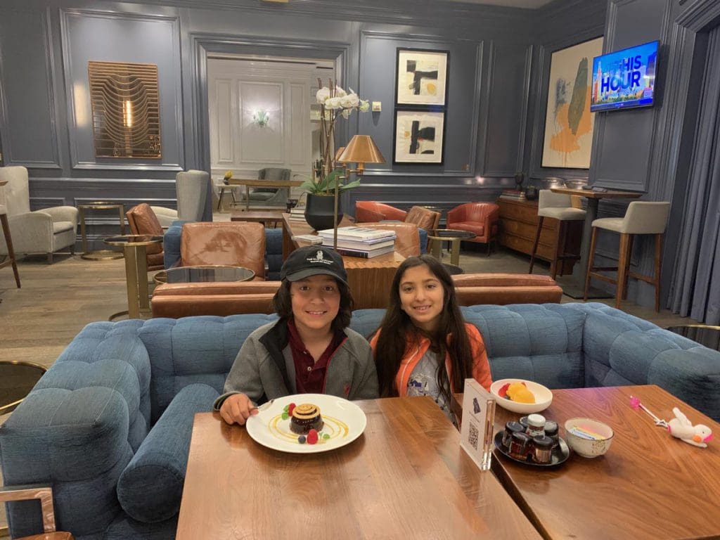 Two young kids enjoy breakfast, while staying at The Ritz Carlton, Washington DC.