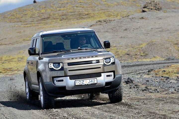 A vehicle moves along a road leading the South Coast of Iceland Private Day Trip by SUV or Van.