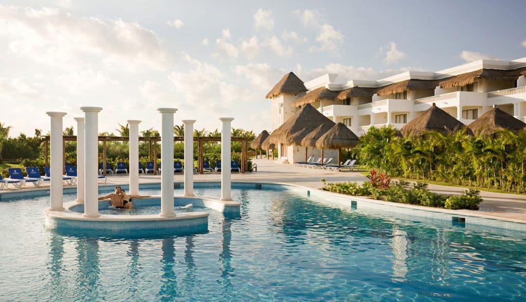 A couple enjoys a little pool time at Grand Riviera Princess, one of the best hotels in Mexico with large rooms for families.