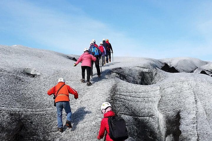 A group of people hike together on a Vatnajökull Glacier Walk from Hali.