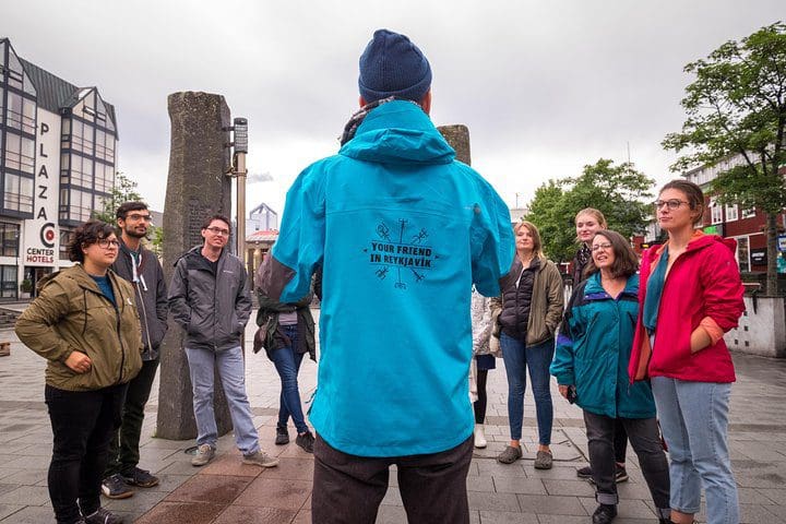 A tour guide talks to guests on the Walk with a Viking: Private Tour of Reykjavik's Top Sights and Local Spots.