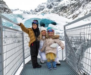 A mom and her two kids explore an ice cave in Iceland.