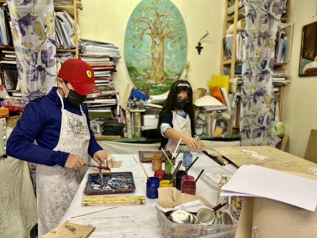 Two young kids enjoy a marble painting class in Florence.