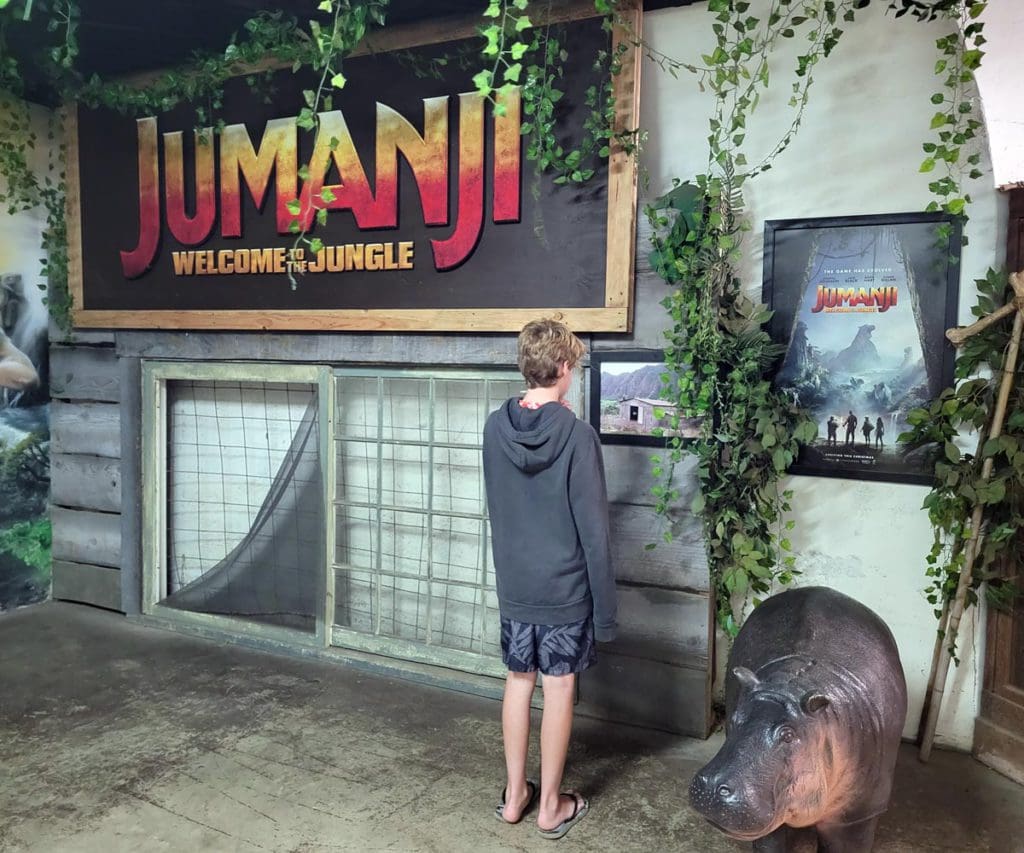 A teen looks at an area dedicated to the film Jumanji, while touring Kualoa Ranch & Private Nature Reserve.