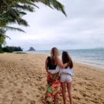 Mother and daughter stand together, enjoying the view at Kualoa Ranch's Secret Island.