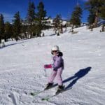 A young girl skis down a slope in Lake Tahoe.