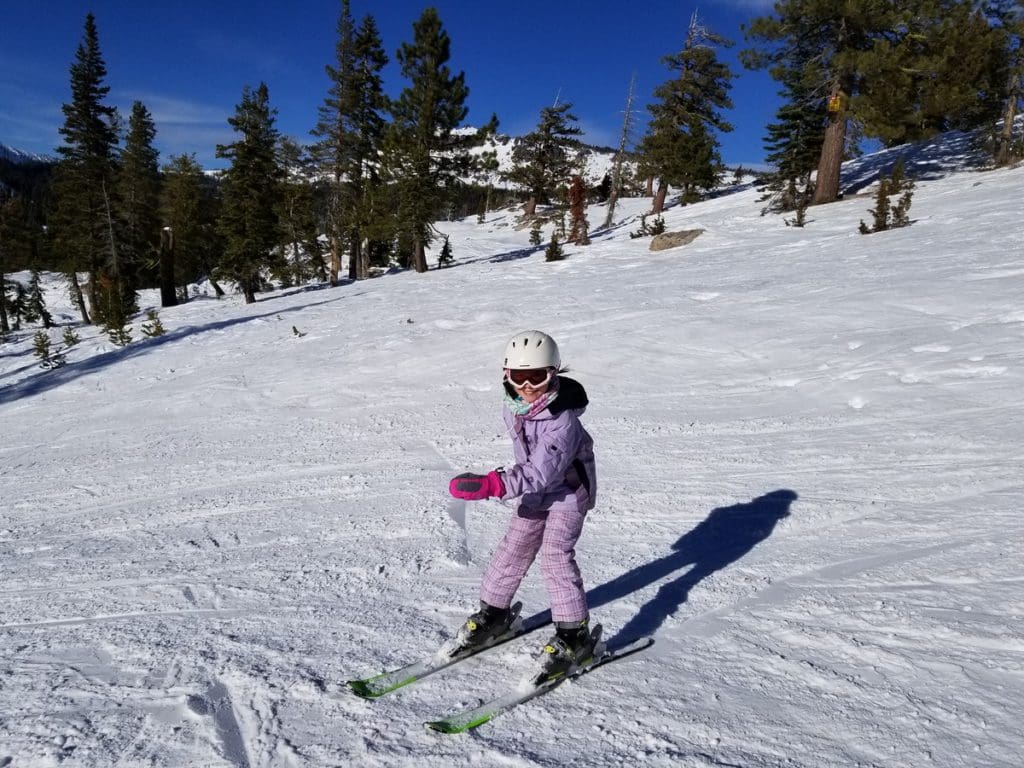 A young girl skis down a slope in Lake Tahoe.