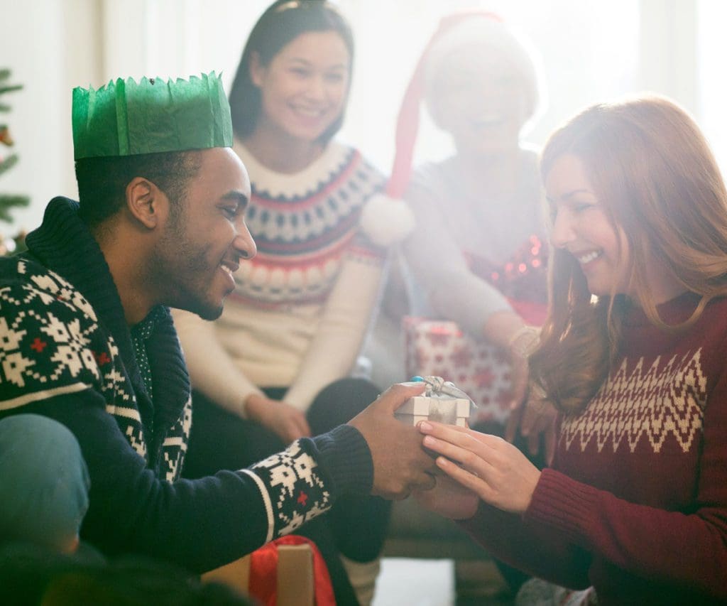 A mom opens her Christmas gift from her family.