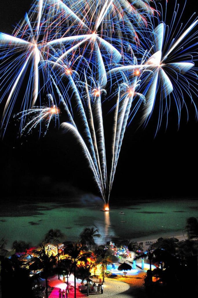 Fire works over the beach for NYE in Aruba, one of the best destinations for New Year's with kids.