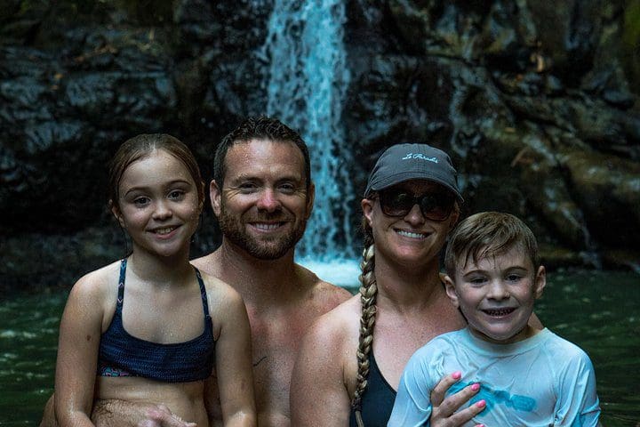 A family poses while experiencing the Full-Day Waterfall Adventure.