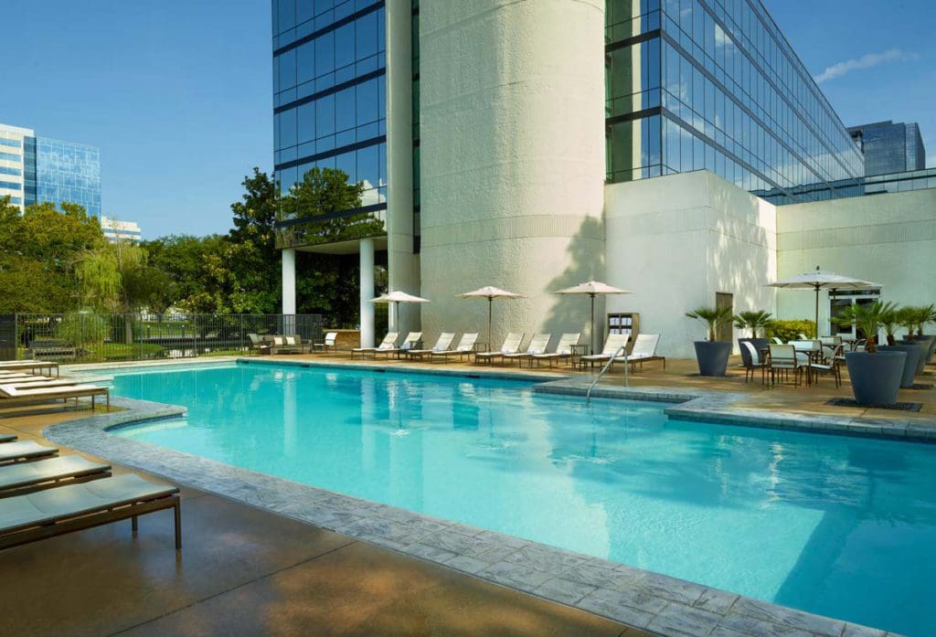 The outdoor pool and surrounding pool deck at Hyatt Regency Houston West.