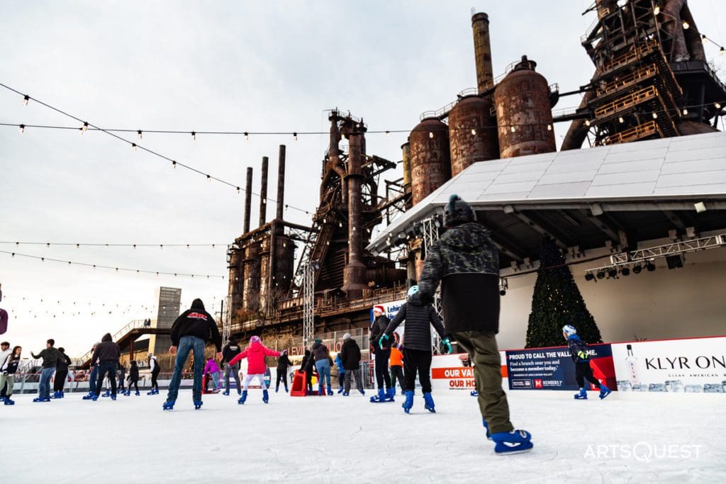 People ice skating on an outdoor rink in Bethlehem, one of the best places near NYC to ring in the New Year with kids.