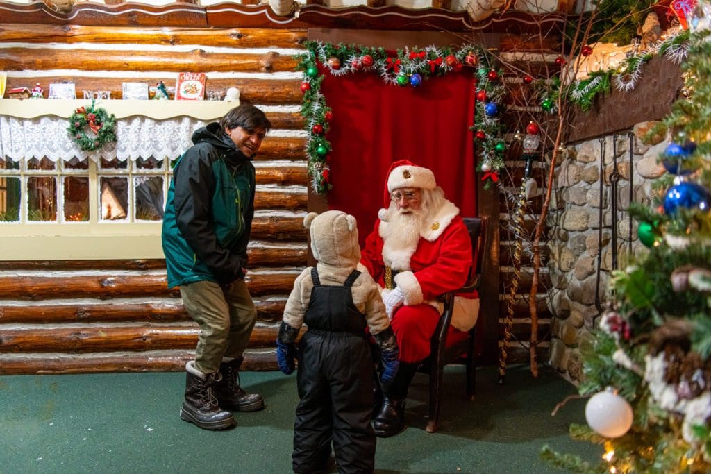 A dad and his young son meet Santa in Lake Placid.