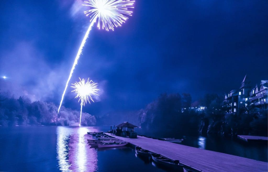 Fireworks over the water at Mohonk Mountain House in New York, one of the best places near NYC to ring in the New Year with kids.