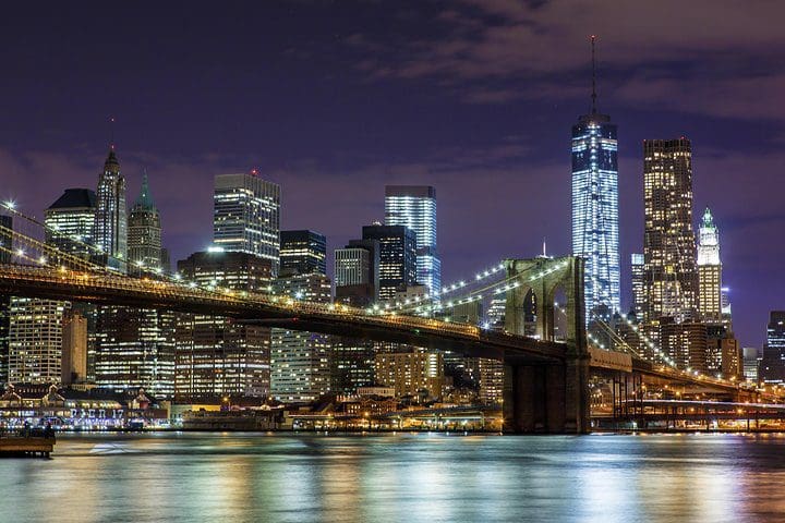 The NYC skyline lit up at night, as seen on the New York City at Night Bus Tour.