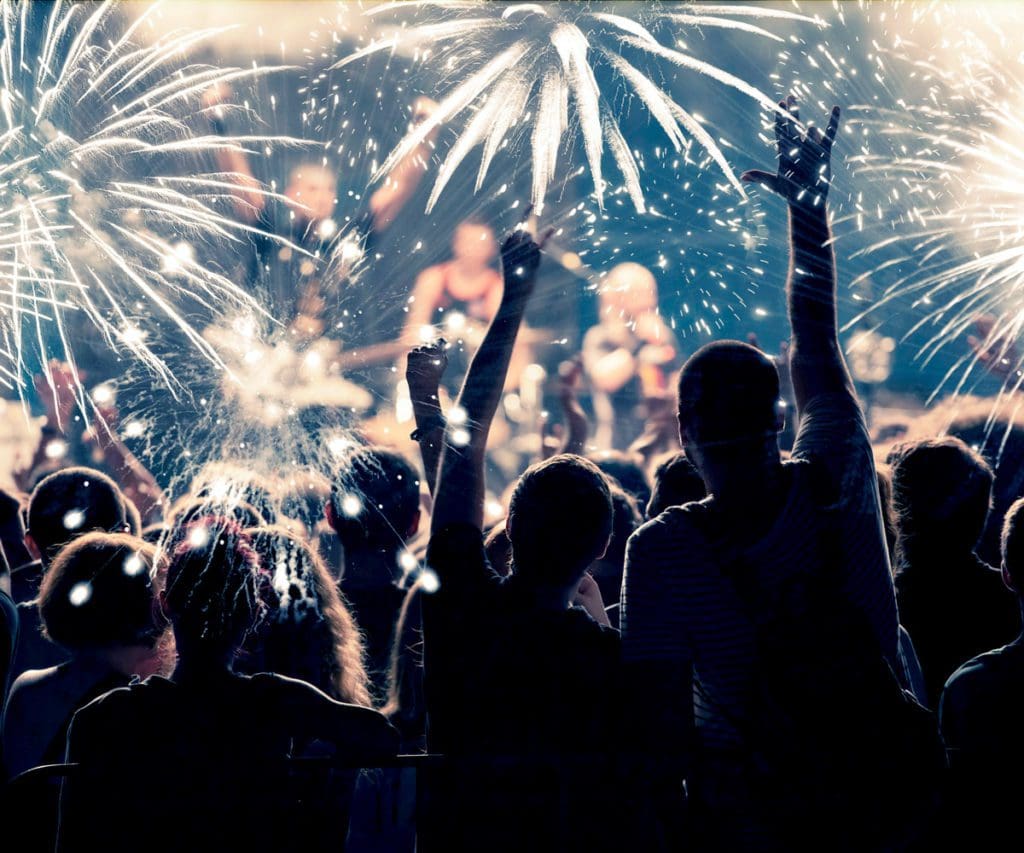 A crowd watching New Year's Eve fireworks in New York City, one of the best places to celebrate the New Year on the East Coast.