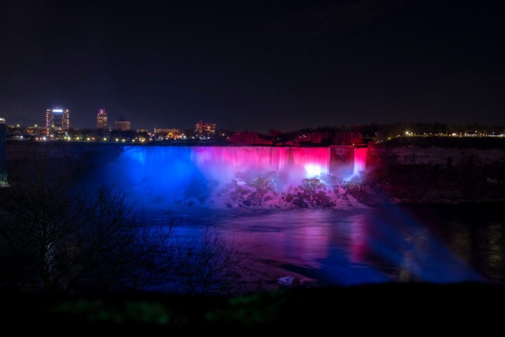 Niagara Falls lit up with a rainbow of colors during the Winter Festival around Christmas.