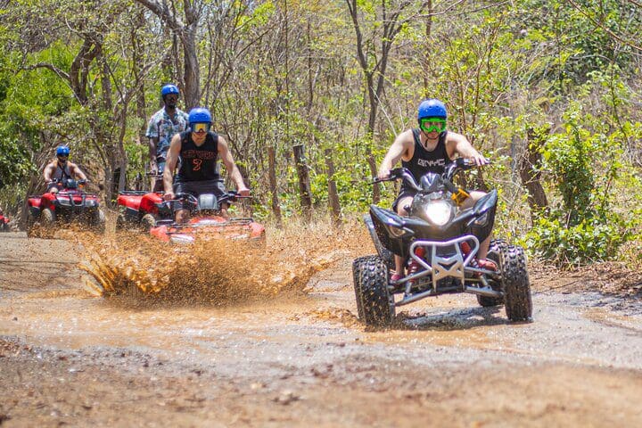 A tour of ATVers moves along a trail on the Private ATV or Buggy Tour from Tamarindo/Conchal & More tour.