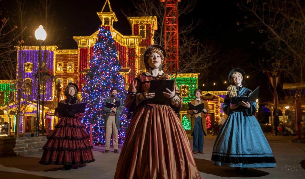 Carolers sing at a holiday even in Silver Dollar City, one of the best budget-friendly Christmas destinations in the US for families.