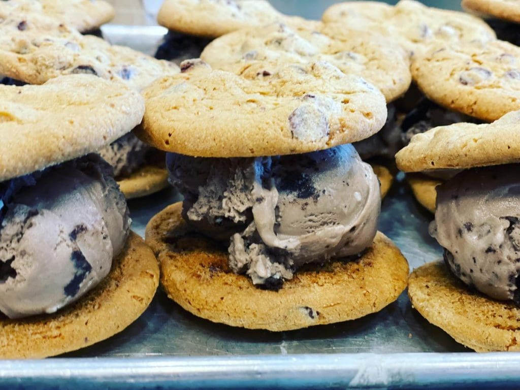 Several ice cream sandwiches from Sweet Cow Ice Cream lined up.