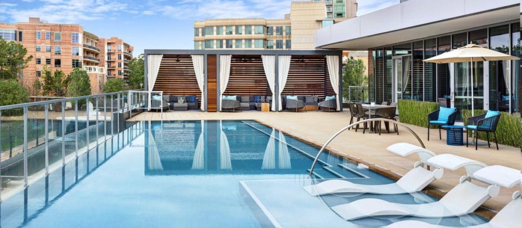 The outdoor pool and surrounding pool deck at The Westin at The Woodlands.