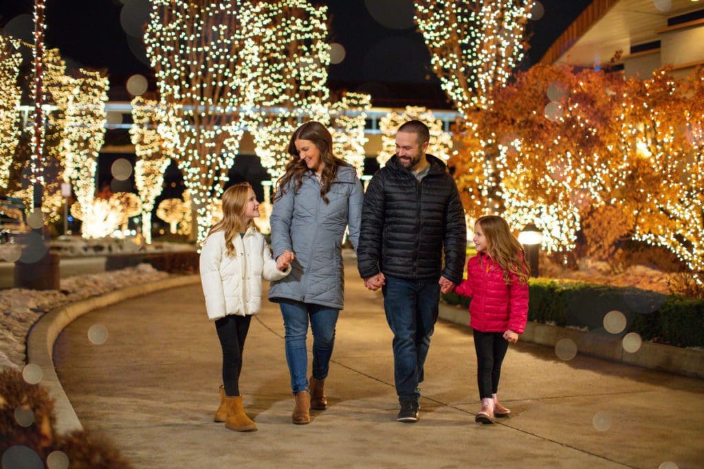 A family of four walks through holiday light displays in Coeur d'Alene.