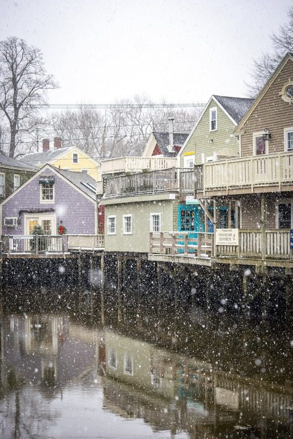 Snow falling on a port in Maine, one of the best places for a White Christmas in the United States for families.