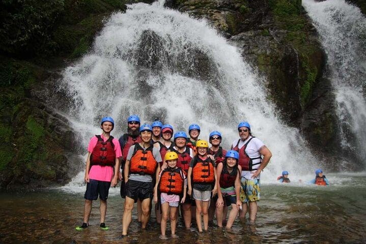 A tour group poses together while on the Whitewater Rafting Savegre Class II-III plus Waterfall Manuel Antonio.