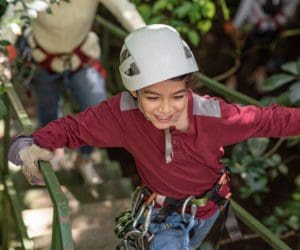 A young boy enjoys a zip-line experience in Costa Rica.