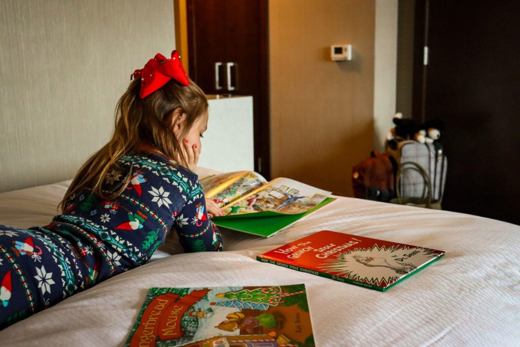 A young girl reads Christmas books, while staying at the JW Marriott Minneapolis Mall of America.