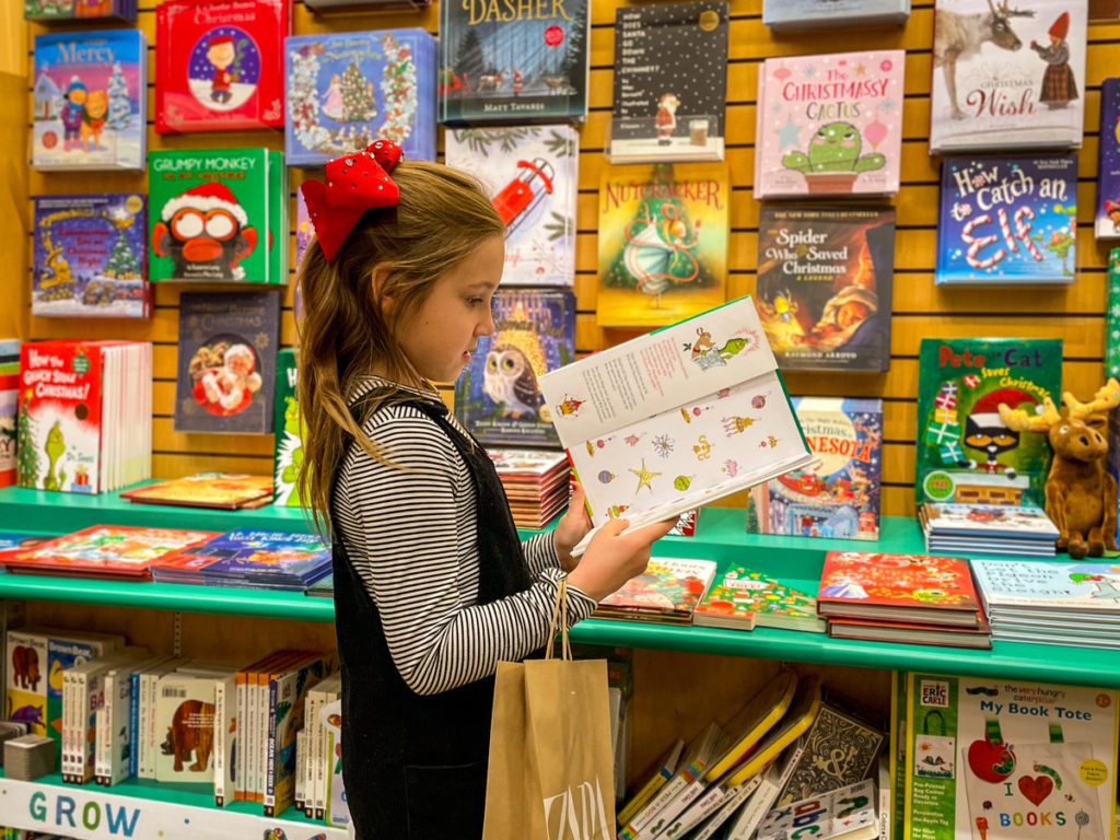 A young girl looks at a book, while shopping at Barnes & Noble in the Mall of America.