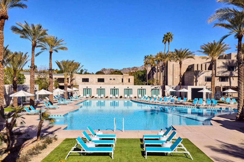The outdoor pool surrounded by palm trees and lounge chairs at the Arizona Biltmore