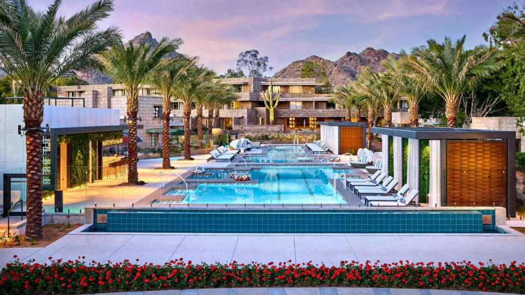 The outdoor pool at the Arizona Biltmore in Phoenix surrounded by mountains and palm trees