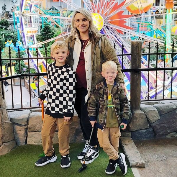 A mom and her two young kids mini golf at Moose Madness.