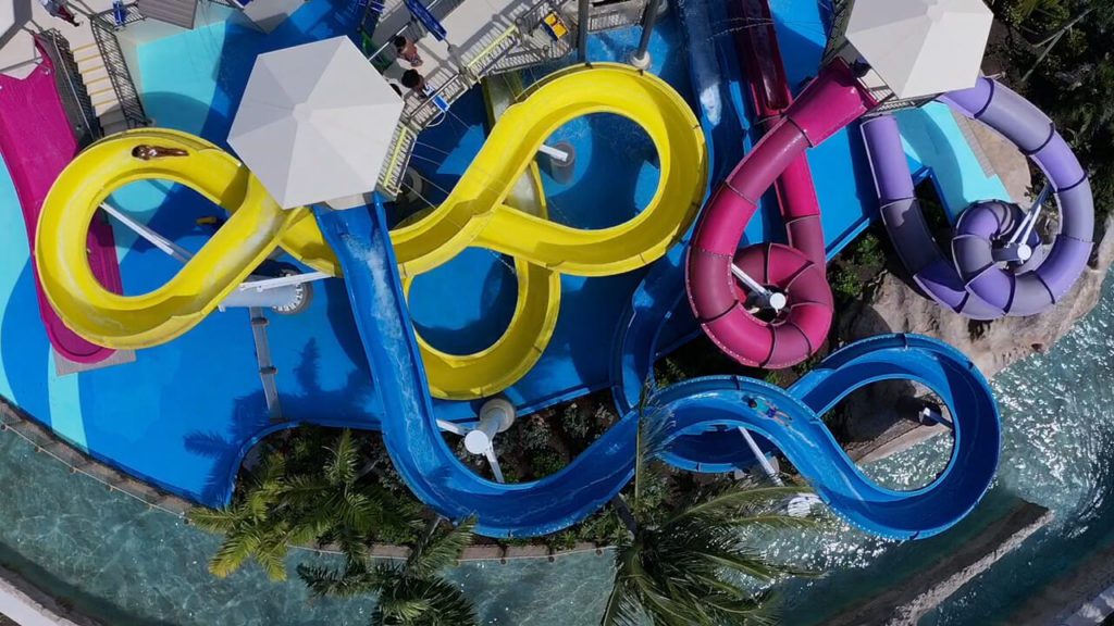 An aerial view of yellow, pink, and blue colorful slides at the Baha Bay Waterpark in Nassau, Bahamas.