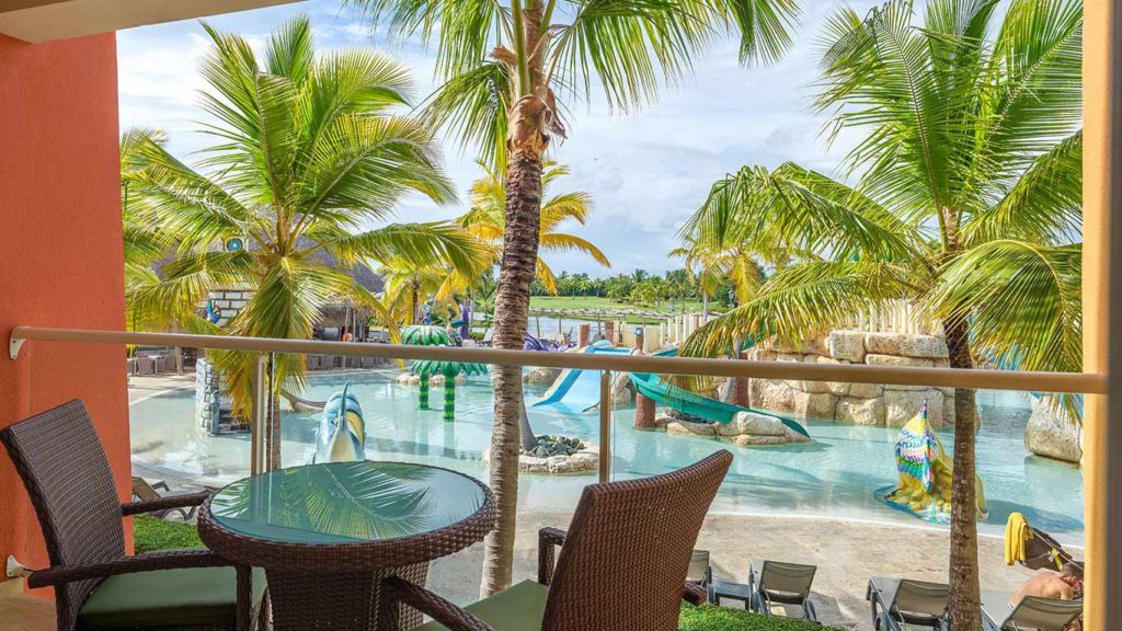 A view of the pool and water park with a slide at Barceló Bávaro Palace.