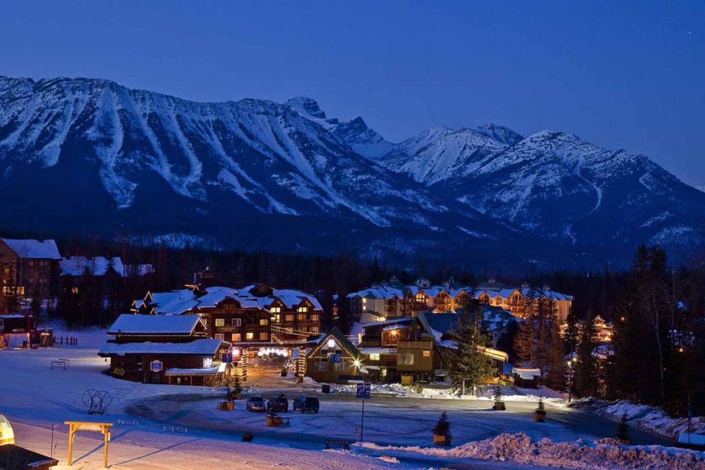 A nighttime shot of the Fernie Alpine Resort surrounded by the town of Fernie