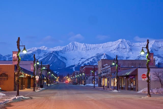 A nighttime view of the Fernie Alpine Resort surrounded by the town of Fernie