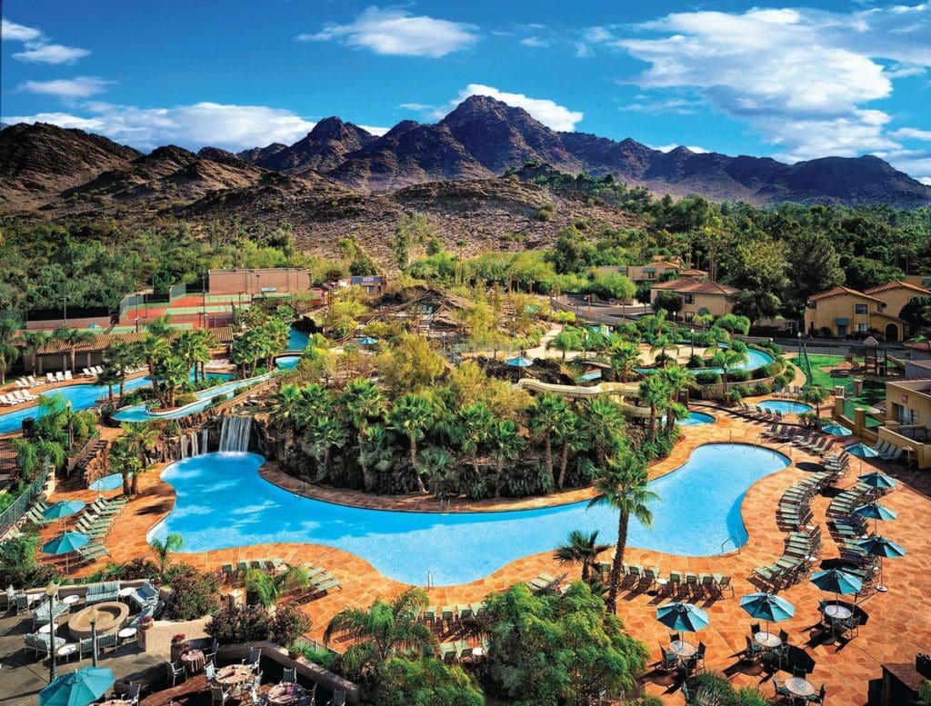 The outdoor pool surrounded by greenery at the Hilton Phoenix Resort at the Peak