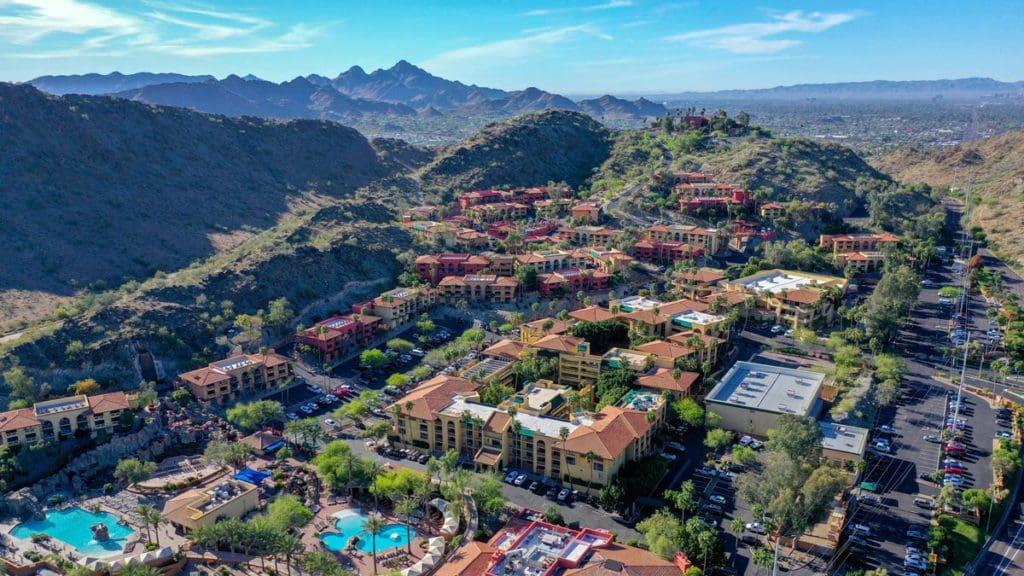 An aerial view of The Hilton Tapatio Cliff Resort surrounded by cliffs and greenery. It's one of the best hotels in Phoenix for families!