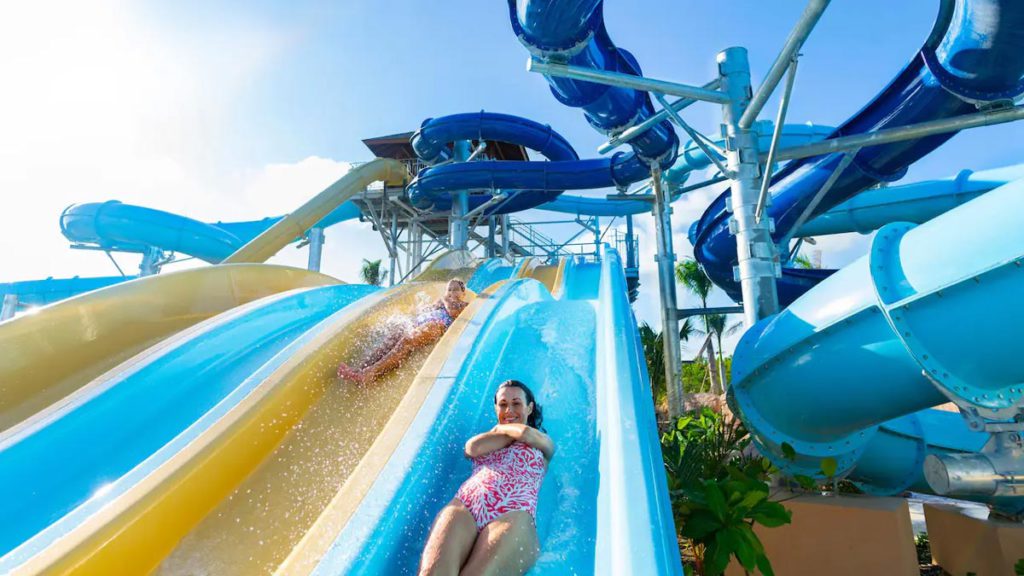 A girl going down the water slide at the Hyatt Ziva Cap Cana, one of the best resorts in the Dominican Republic for families!