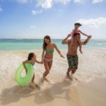 A family running on the beach at the Royalton Bavaro Resort and Spa, one of the best resorts in the Dominican Republic for families!