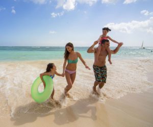 A family running on the beach at the Royalton Bavaro Resort and Spa, one of the best resorts in the Dominican Republic for families!