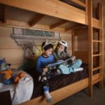 Two young kids reading on a bunk bed at the Great Wolf Lodge in Bloomington, Minnesota