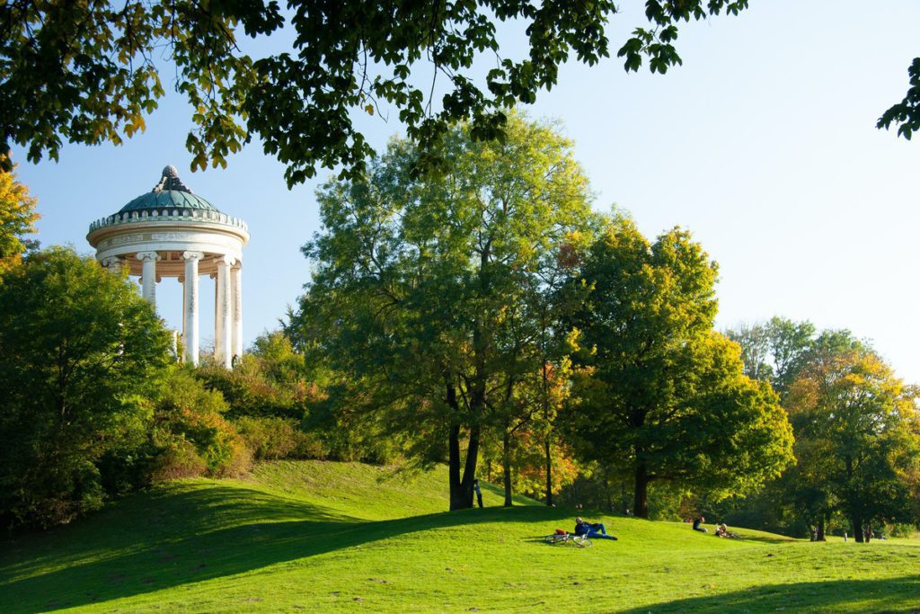 People relaxing in the English Garden in Munich, one of the best places to visit in Germany with kids.