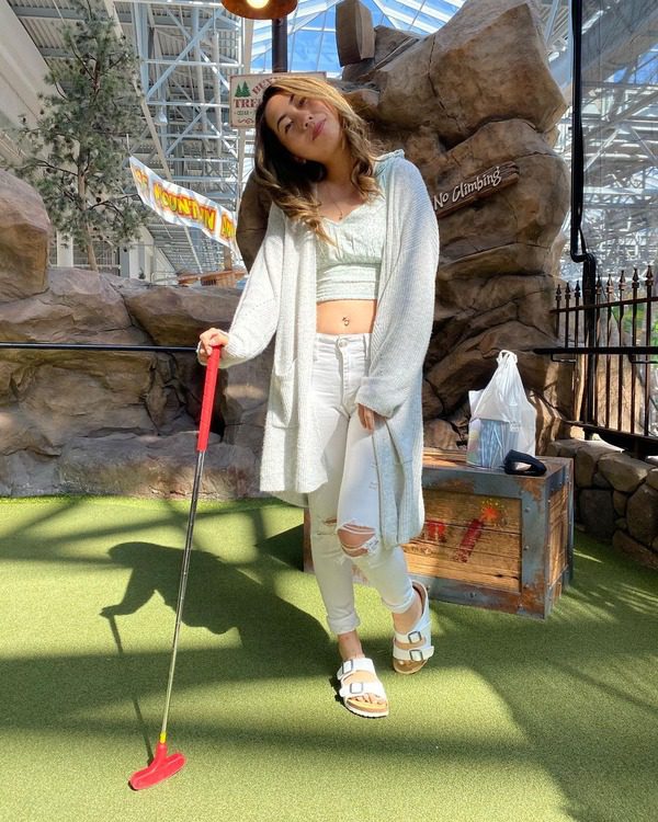A woman poses as she mini golfs in the Mall of America.