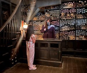 A girl shopping for wands at Universal Studios Orlando.