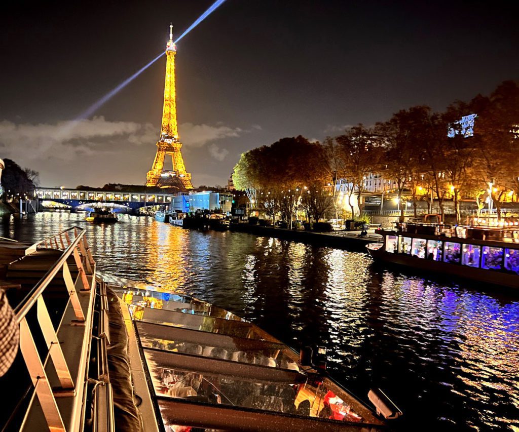 A riverboat tour on the Seine River in Paris at night. This is one of the best things to do on a Paris itinerary with preteens or teens.